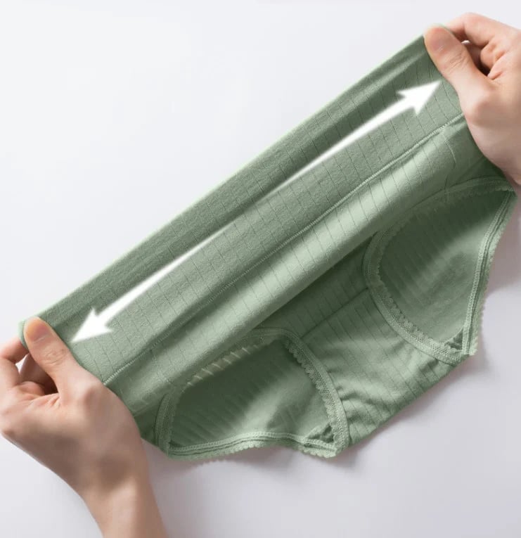 A photo realistic image of a pair of hands holding a green antibacterial humid-absorbing face mask that is made of a soft, ribbed fabric and has two white arrows pointing in opposite directions on it, folded in half with the inside visible. A photo realistic image of a pair of hands holding a green antibacterial humid-absorbing face mask that is made of a soft, ribbed fabric and has two white arrows pointing in opposite directions on it, folded in half with the inside visible.